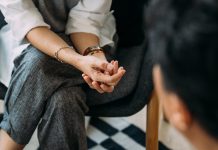 Close-up of woman's hands during counseling meeting with a professional therapist.