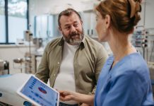 Female doctor consulting with overweight patient, discussing test result in doctor office. Obesity affecting middle-aged men's health. Concept of health risks of overwight and obesity.