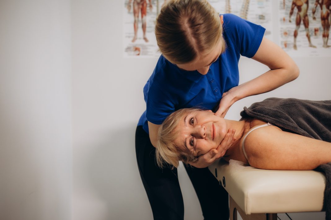 senior woman at an appointment with a chiropractor