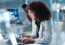 Woman. laptop and lab for research science or online internet for futuristic discovery, microscope or medicine. Female person, brainstorming and biotechnology for investigation, cure or development