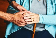 Home caregiver showing support for elderly patient.