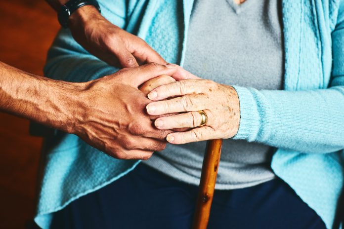 Home caregiver showing support for elderly patient.