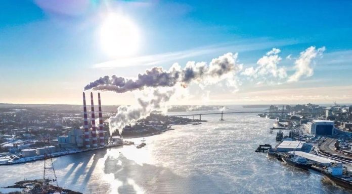 On the left is an aerial view of Halifax Harbour with a local power plant, as indicated by the three cooling towers. Credit: Noah James Media