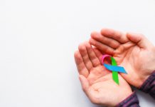 man holding a symbol of World AIDS Day