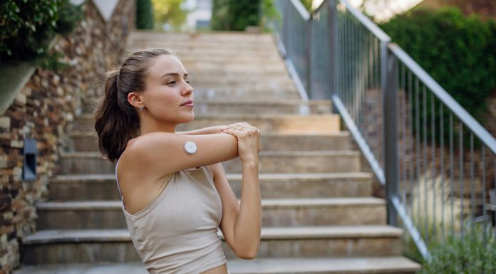 Beautiful diabetic woman preparing for outdoor run in the city.