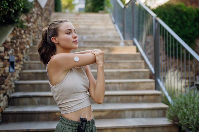 Beautiful diabetic woman preparing for outdoor run in the city.