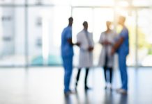 Blurred shot of a team of doctors standing together in a hospital