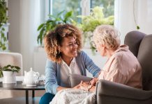 Friendly nurse supporting an eldery lady