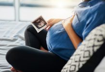 Closeup shot of an unrecognizable pregnant woman holding an ultrasound scan