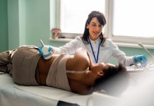 Medical specialist conducts an examination of the kidneys of patient