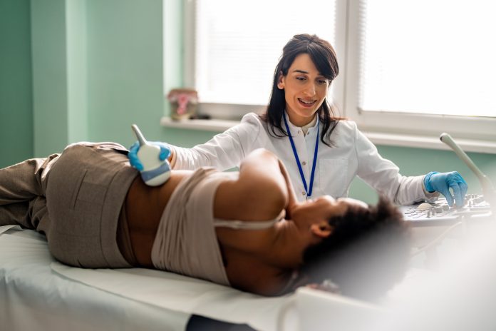 Medical specialist conducts an examination of the kidneys of patient