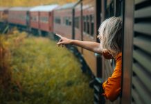 A woman enjoys a train ride in Sri Lanka