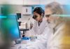 Female Scientist Working in The Lab, Using Microscope