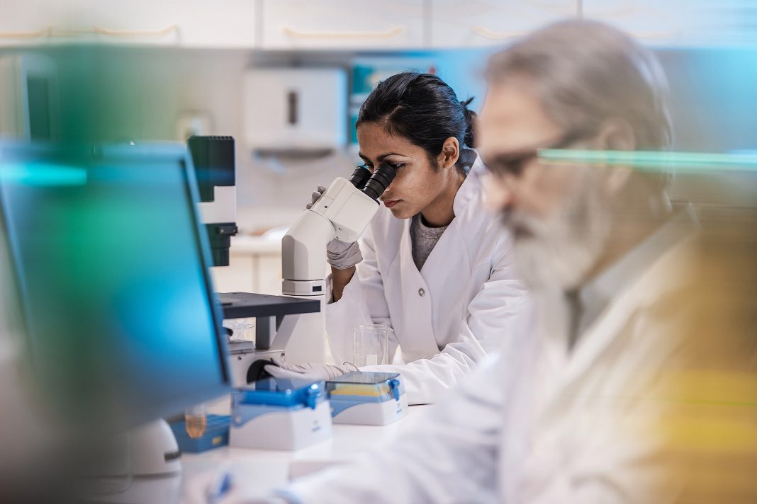 Female Scientist Working in The Lab, Using Microscope