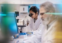 Female Scientist Working in The Lab, Using Microscope