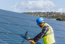 Engineer Man at Work: Managing and Optimizing Efficiency at the Solar Energy Photovoltaic Farm with Laptop Technology