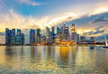 Moody Sky at Sunset over the Office Buildings with Reflection in Marina Bay