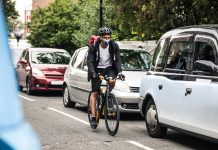 Cyclist commuter wearing a pollution-mask in Central London