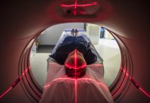 Patient lying inside a medical scanner in hospital