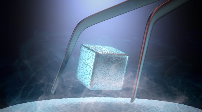 Image concept of magnetic levitating above a high-temperature superconductor, cooled with liquid nitrogen.