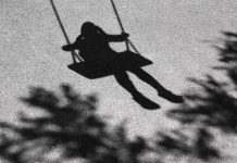 Blurry shadows of girl on a swing and a tree branch