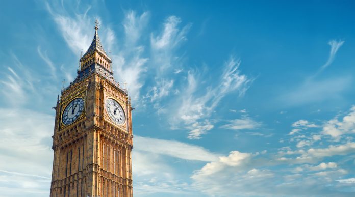 Big Ben Clock Tower in London, UK, on a bright day. Panoramic composition withcopy-space, text space on blue sky with feather clouds.