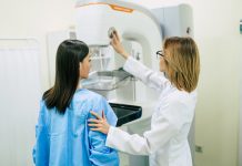 Young woman is having mammography examination at the hospital or private clinic with a professional female doctor.