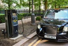 Electric London cab plugged into a recharging point