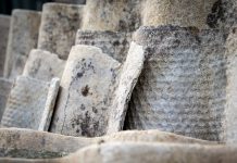 Old roofing slate in a pile. Asbestos, harmful to humans and the environment. Close up.