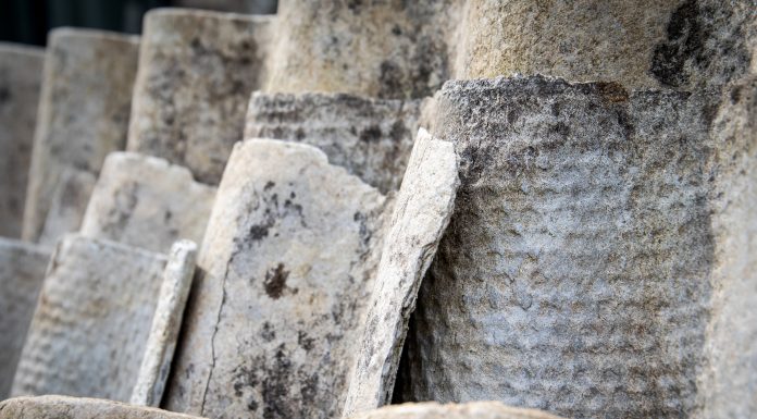 Old roofing slate in a pile. Asbestos, harmful to humans and the environment. Close up.