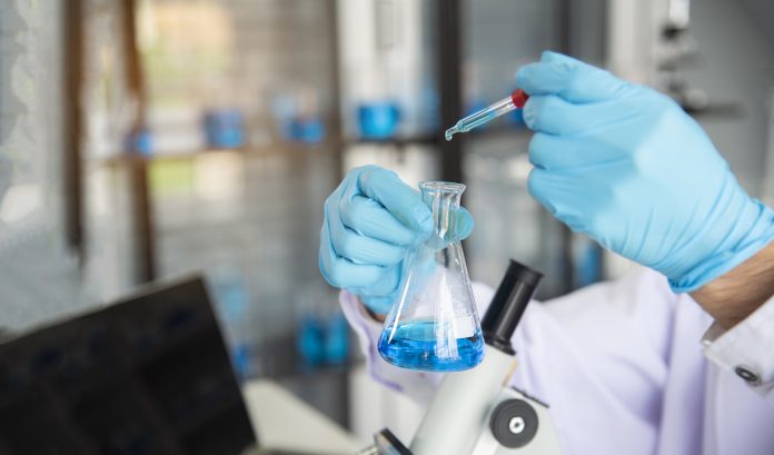 Hand scientists study health care and researchers doing some research with dropper chemical testing and working in life science laboratory.