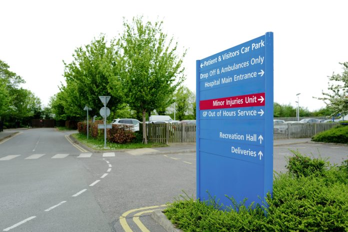 Typical NHS styled information sign seen adjacent to an outpatient car park in a British hospital.