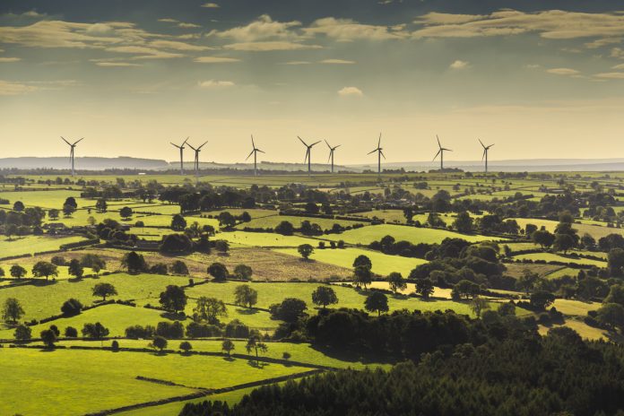 Wind turbines and farmland near Leeds, West Yorkshire. Aerial view from a helicopter