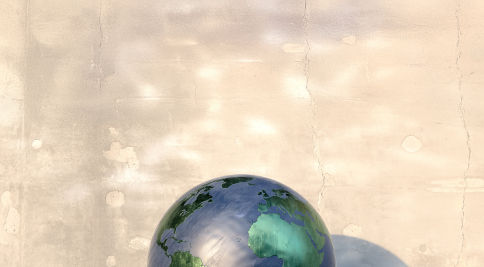 A spherical model of planet earth sitting on a concrete shelf on a hot day, deflating and melting. The globe has a blue 'sea' and metallic green 'land' and has drips forming at it's base as it heats up. COP30 will celebrate the tenth anniversary of the Paris Agreement but where, Richard Beardsworth asks, do things stand ten years on?