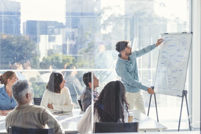 Business people watching a presentation on the whiteboard.