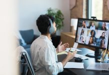 Man in Headphones Participating in a Virtual Group Meeting